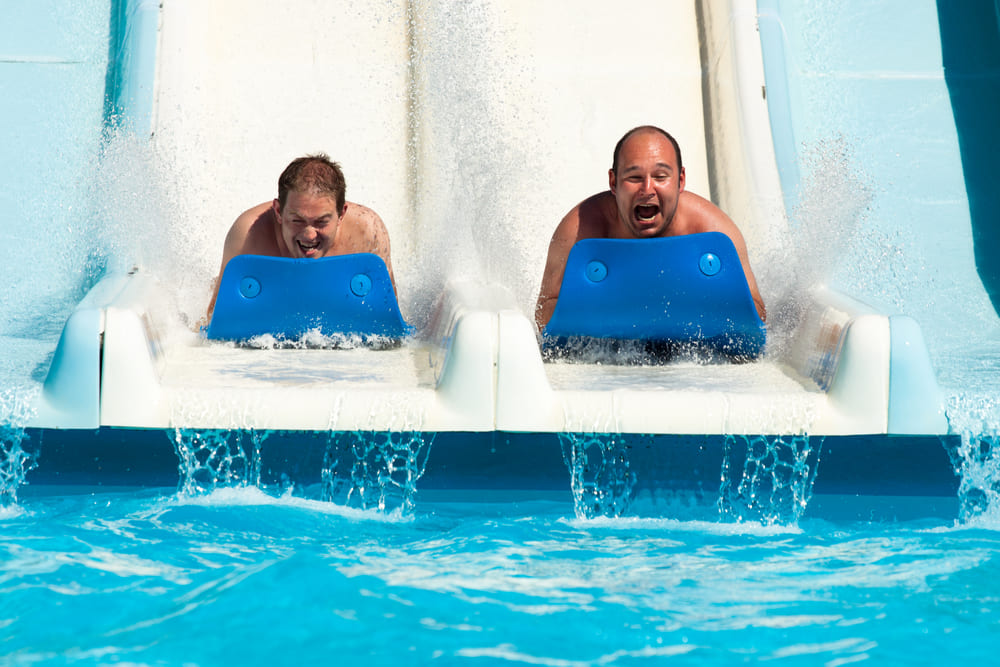 Team members having fun at a slide in a waterpark