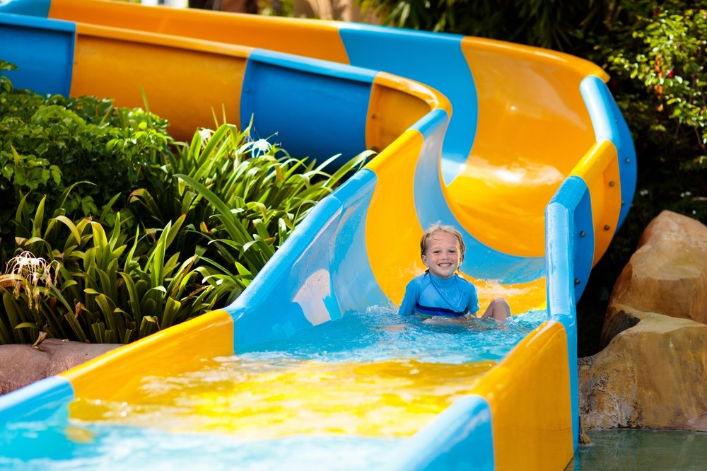 A boy on a water park slide