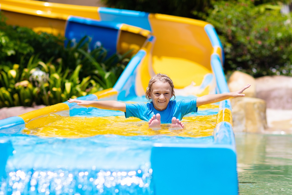 A boy on a water park slide