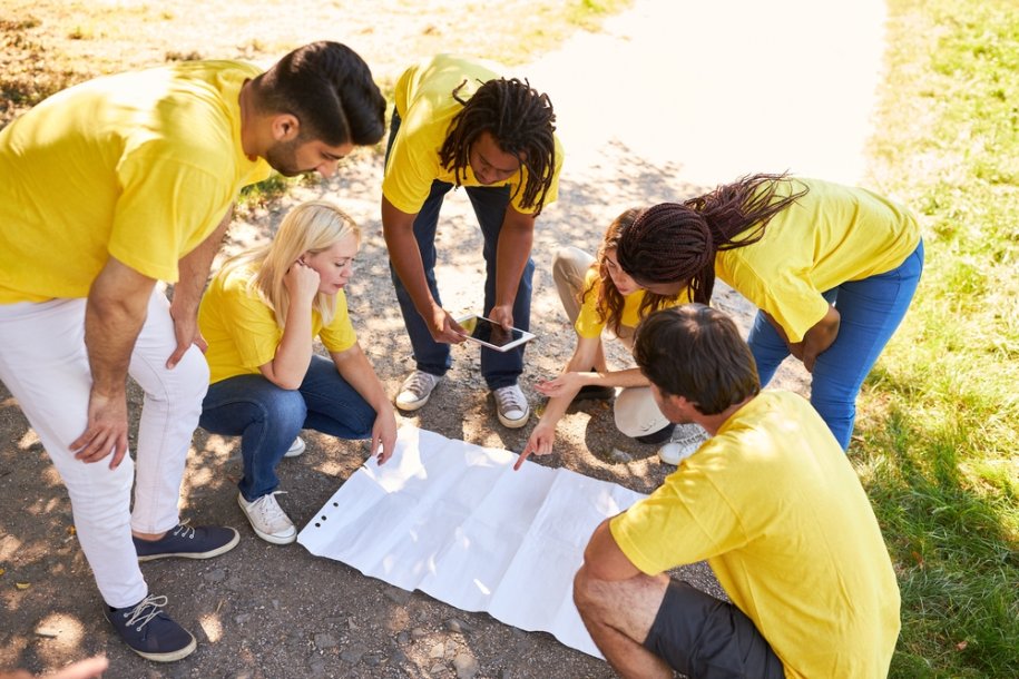 A team discussing their strategy during a scavenger hunt