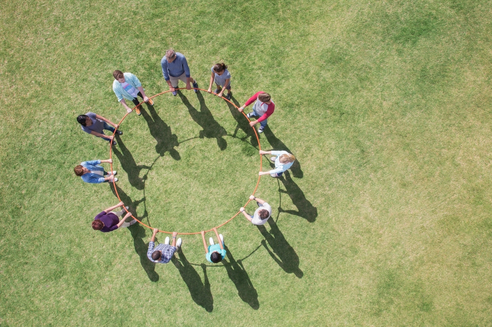 A team forming a circle during a team-building activity