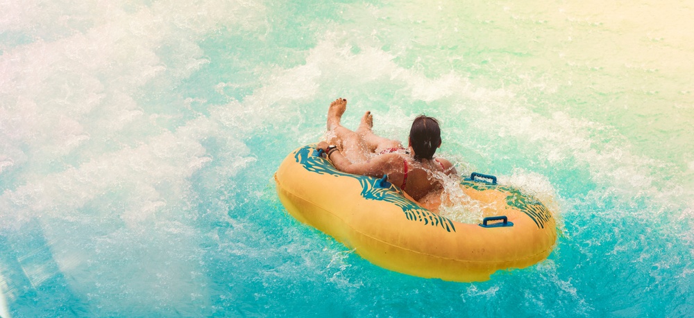 A water park guest in a raft