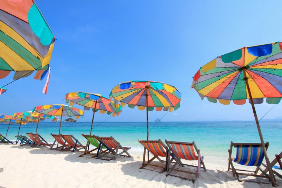 Beach chairs and umbrellas for rent on a Thai beach