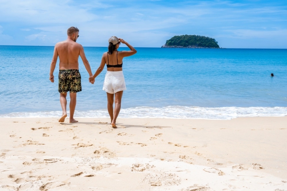 couple on a Thai beach wearing appropriate swimwear