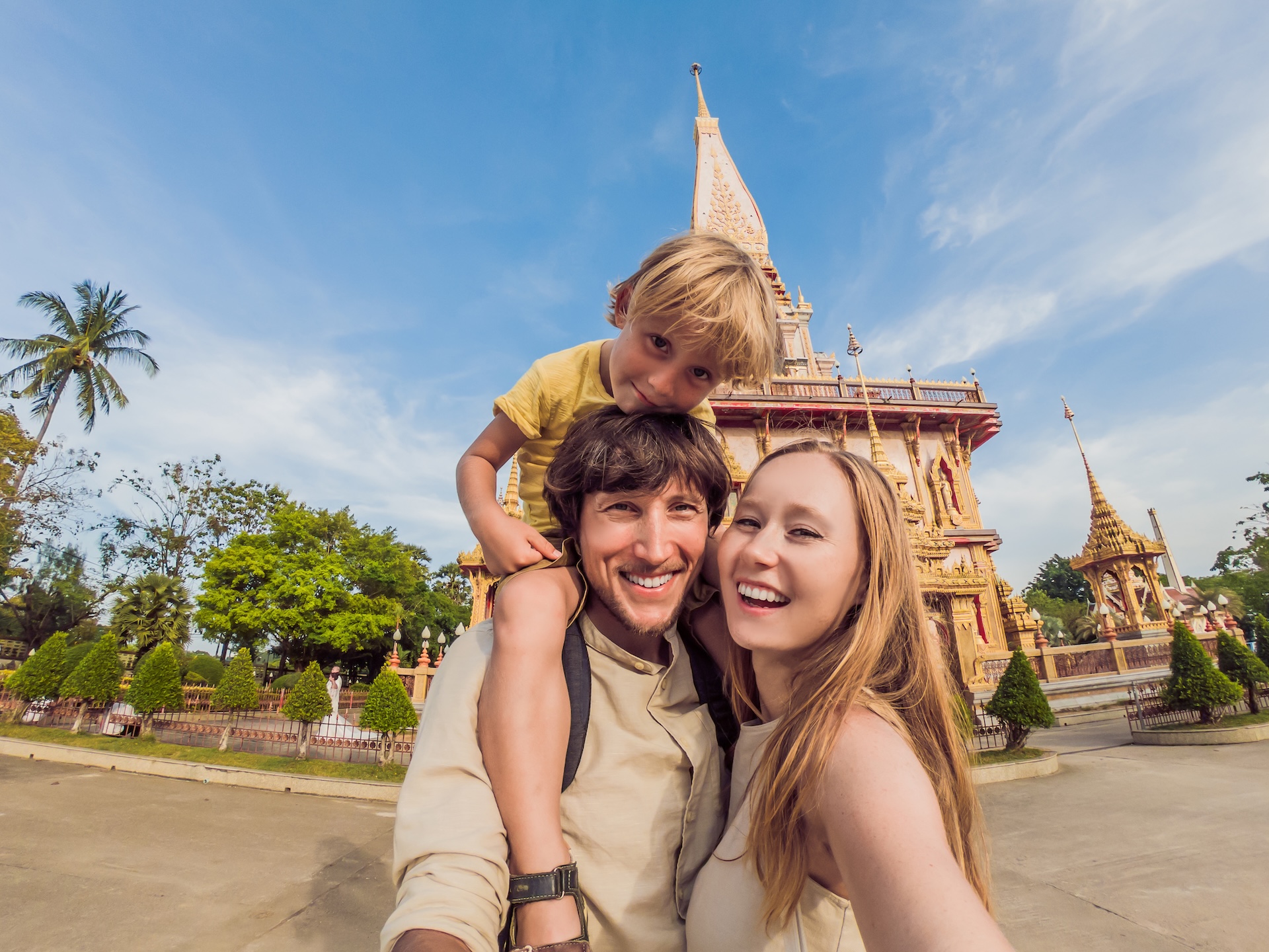 family taking a selfie at a tourist spot in Thailand