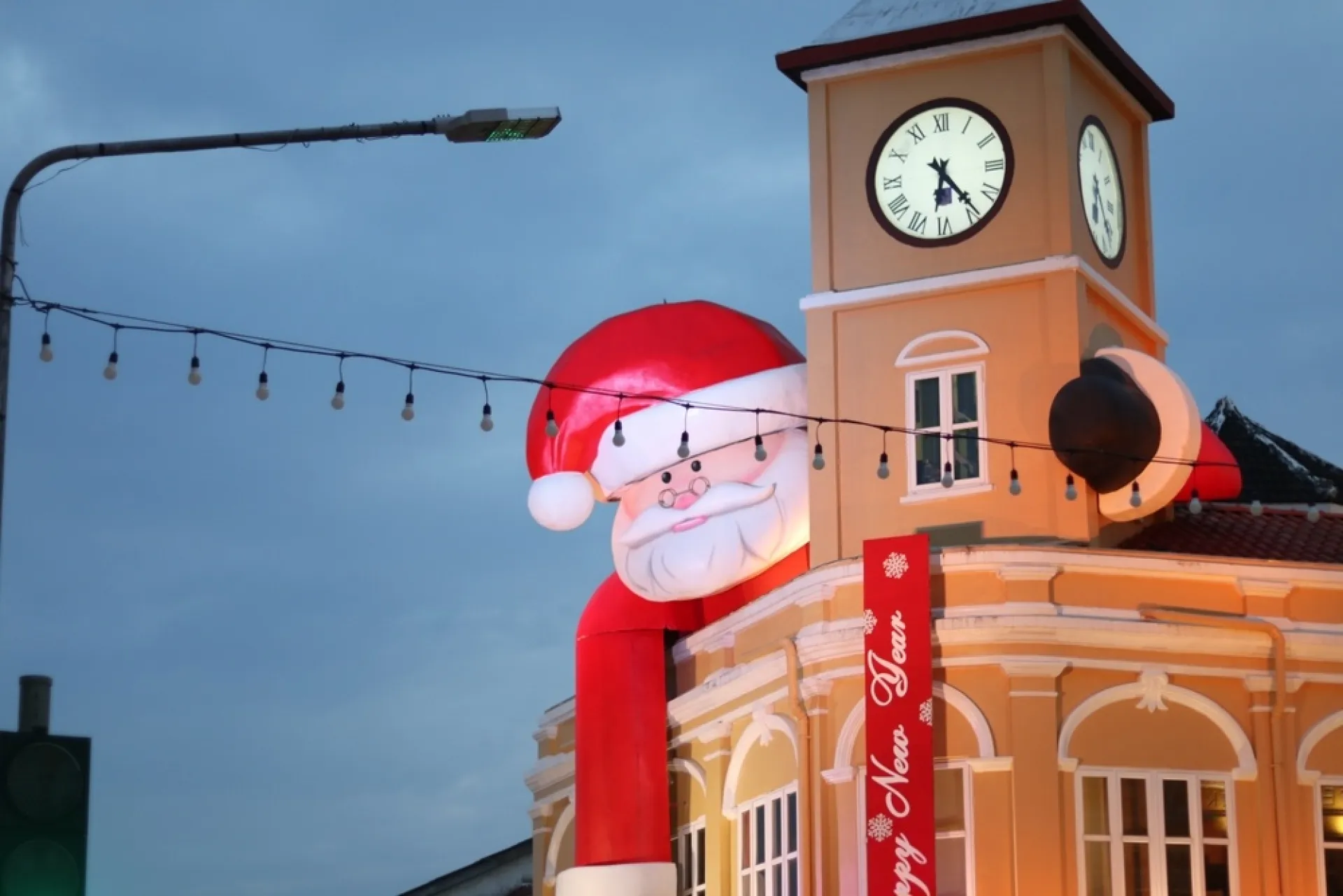 Giant inflatable Santa atop a building in Phuket Town