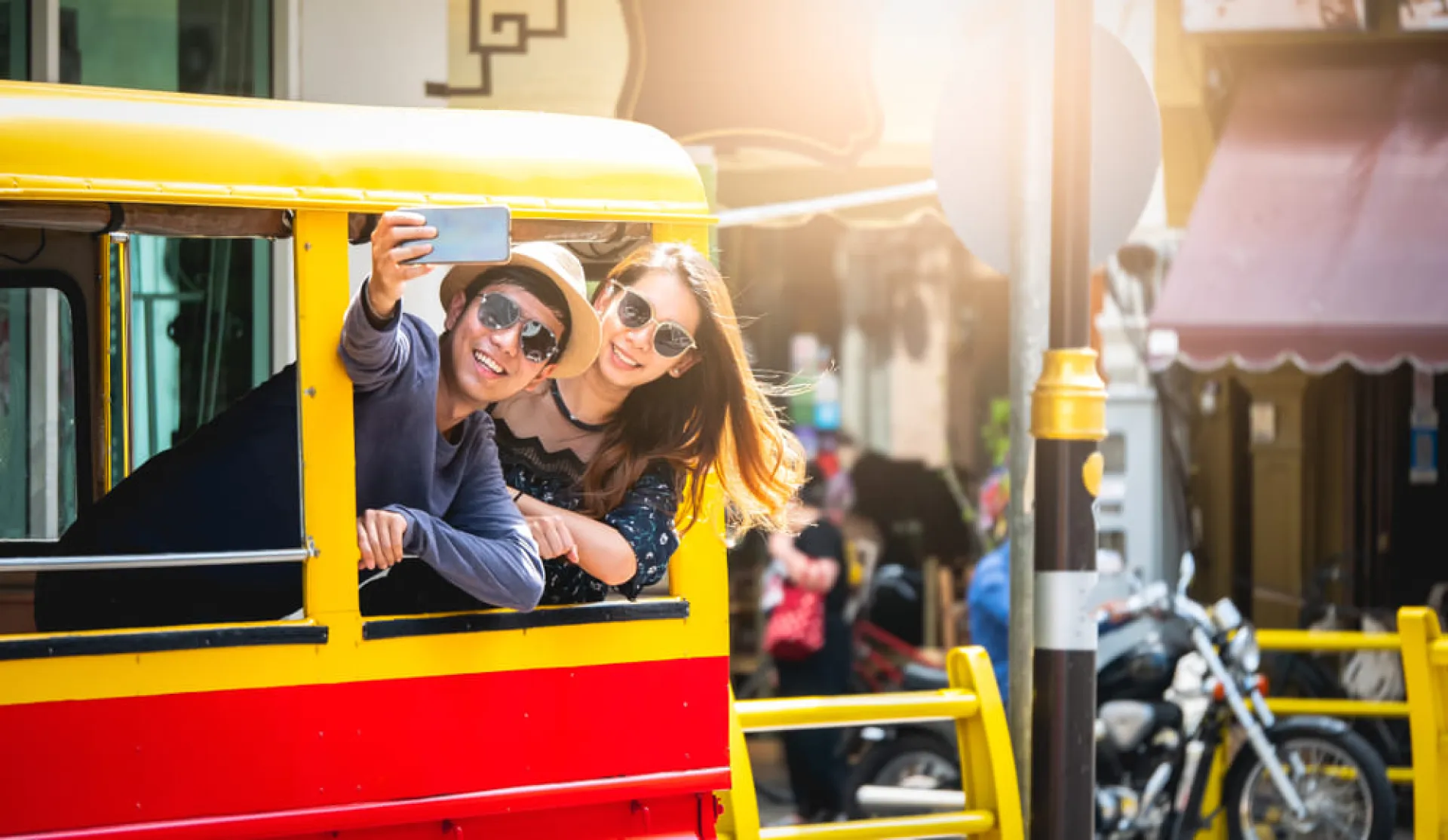 Tourists taking a photo in a tuk tuk in Phuket